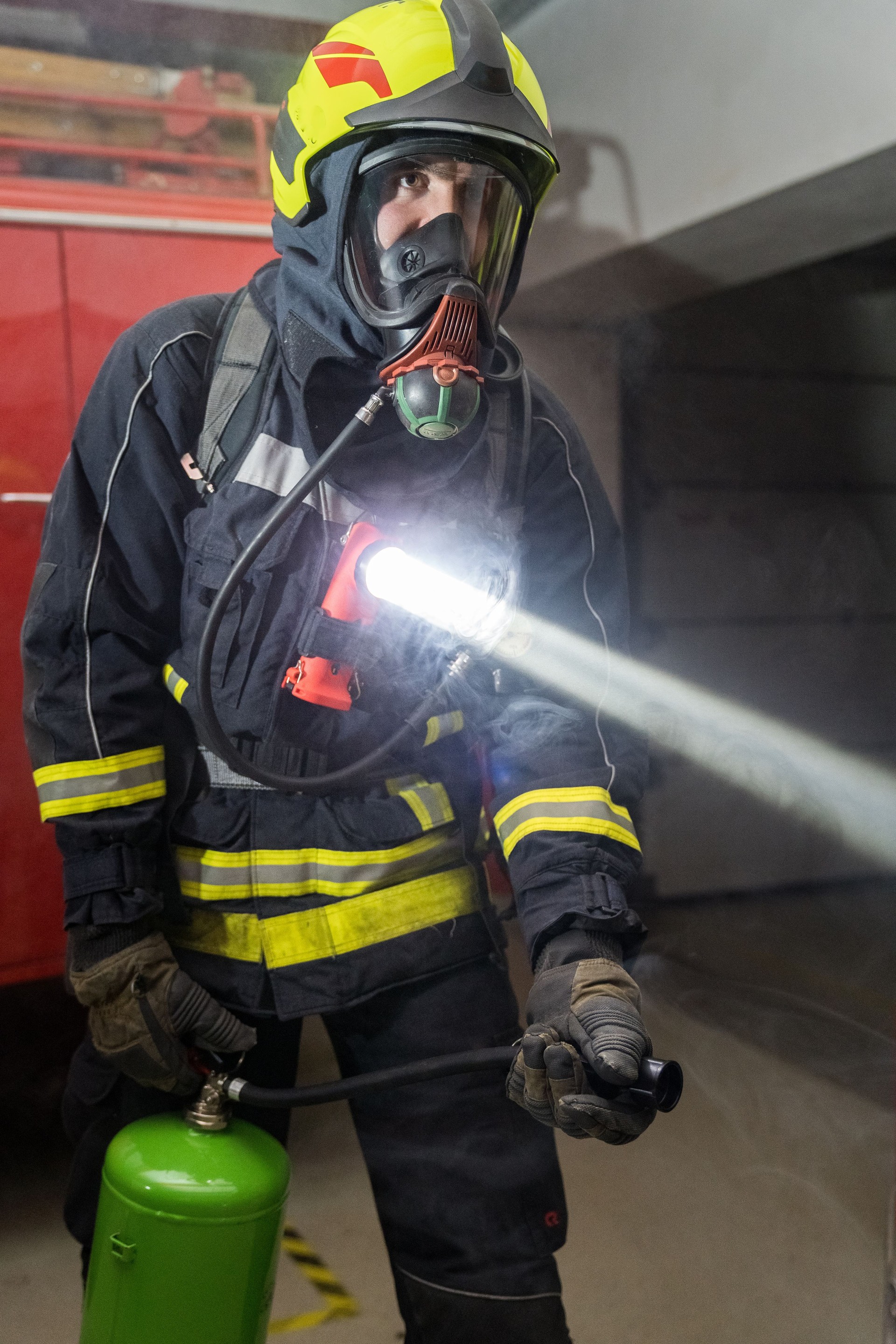 Headshot on fireman wearing full protection equipment and truck